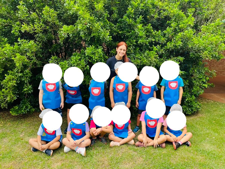 Little chefs in aprons with their teacher